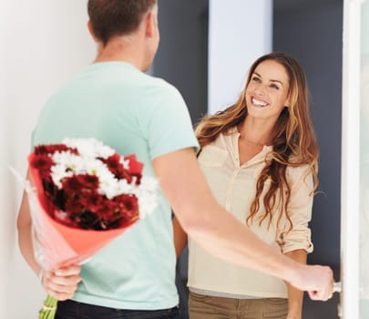 Shes got the best husband ever. a man surprising his wife with flowers.