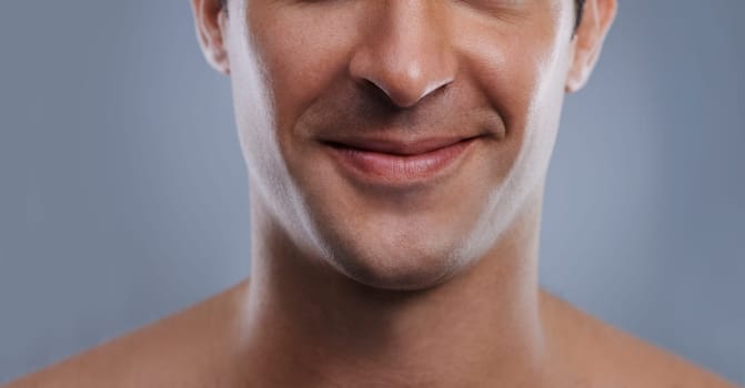 Kissable lips. Cropped image of a handsome mans mouth smiling.
