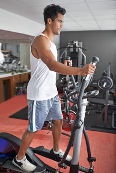 Hes always in the gym. A young ethnic man exercising in the gym.