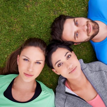 So much potential. High angle shot of a three friends lying down on grass