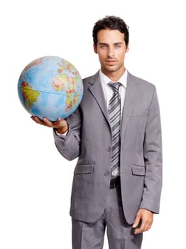 The corporate world is my oyster. A handsome young executive holding a globe while isolated on a white background.