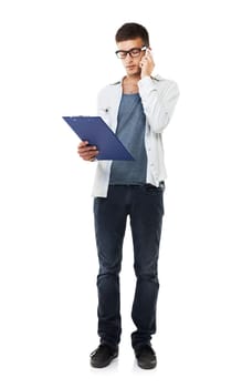 Checking the information. A casual male with glasses on looking at his clipboard with a white background.