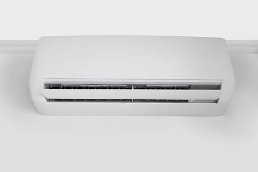 Bottom view on White air conditioner hanging from the ceiling on the wall, copy space
