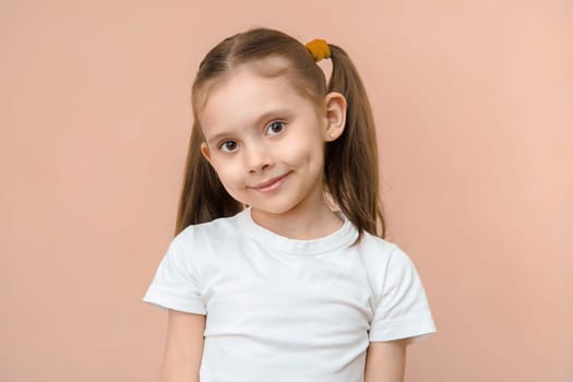 Cute caucasian preschool girl portait on a pink background