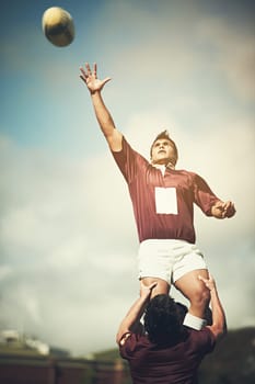 Winning the lineout. a young rugby player catching the ball during a lineout.