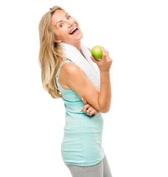Laughing her way to a svelte figure. a mature woman eating an apple against a studio background.