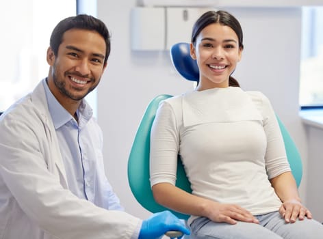 Healthy teeth, happy patient. Portrait of a young woman having a consultation with her patient in a dentists office.