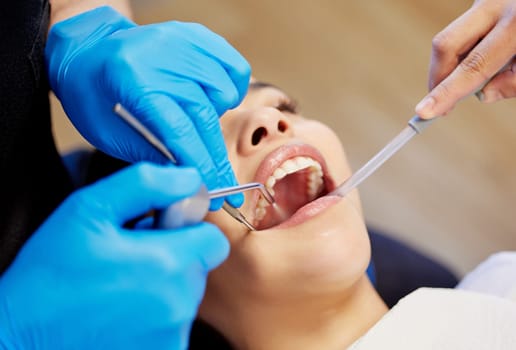 Bright, brighter, brightest. a young woman having a dental procedure performed on her.