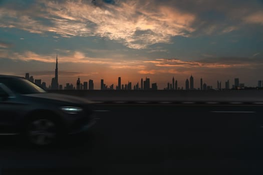 Dubai over sunset with a slow motion luxury car