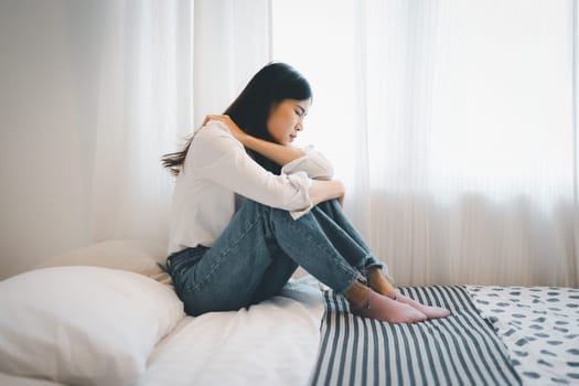 Young attractive asian woman lying at home living room couch feeling sad tired and worried suffering depression in mental health, problems and broken heart concept.