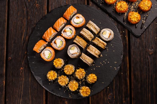 Rolls set with fish shrimp and caviar sushi with chopsticks - asian food and japanese cuisine concept top view