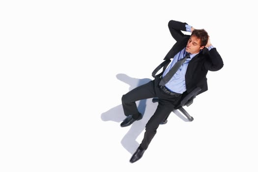 Top view of a relaxed business man sitting on a chair. Top view of a relaxed young business man sitting isolated on a chair on white.