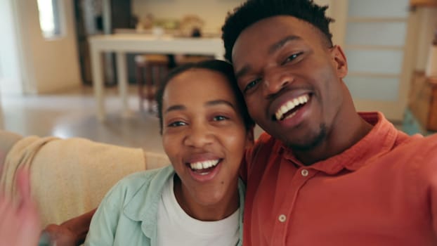 Video call, wave and love with a black couple laughing together while talking on a call in their home. Happy, communication and smile with a young man and woman having fun and calling with technology.