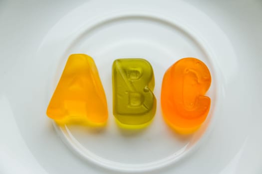 Jelly bean sweets and ABC letters. Education and alphabet concept.food sweet letters. Sweet alphabet. ABC text, Message lined with edible letters, Letters ABC for children alphabet learning . healthy eating