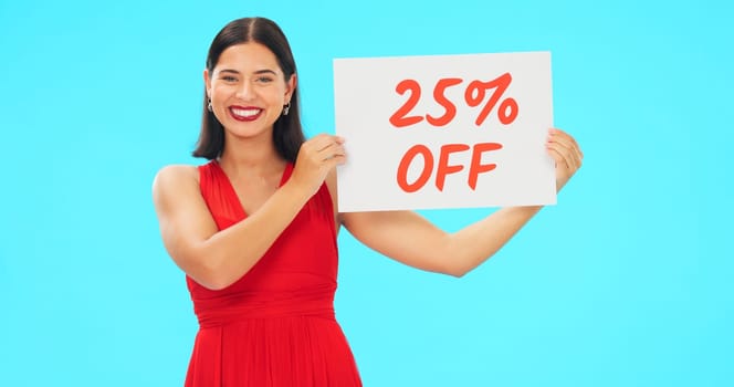 Woman, portrait and sale sign for studio advertising percentage or discount rate on paper or banner. Smile of a happy female on a blue background for fashion promotion deal, savings or deal and offer