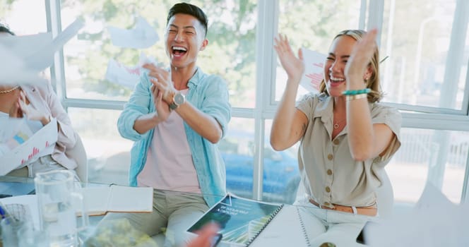Teamwork, winner or high five with a business team throwing documents during applause at a meeting. Paperwork, collaboration and motivation with a man and woman employee in celebration at the office.