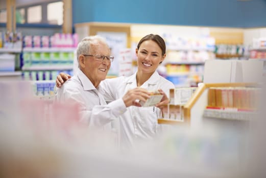 Every client is an individual. a young pharmacist helping an elderly customer.