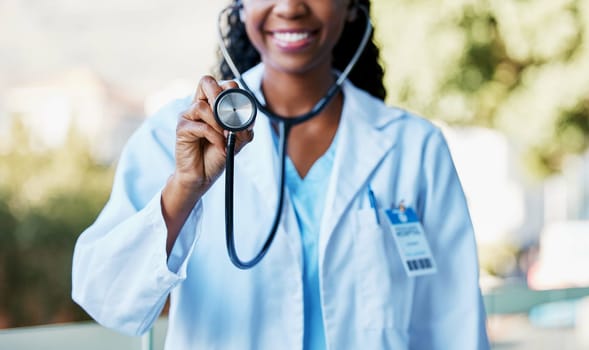 Woman, stethoscope and cardiology doctor for healthcare, life insurance and medical care for wellness. Hand of medicine professional or expert for heart health, healing or hospital consultation check
