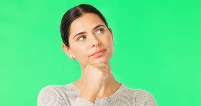 Face, idea and option with a woman on a green screen background in studio to consider a decision. Thinking, mind and contemplating with an attractive young female looking thoughtful on chromakey