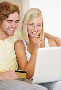 Thats exactly what I want. A happy young couple doing their online banking from the comfort of their couch.