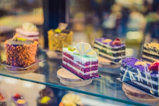 Different types of cakes in pastry shop glass display