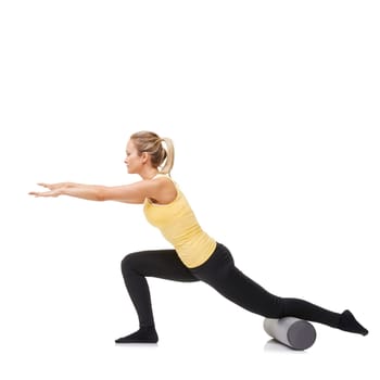 Lunging forward. A young woman performing lunges while using a foam roller - isolated.