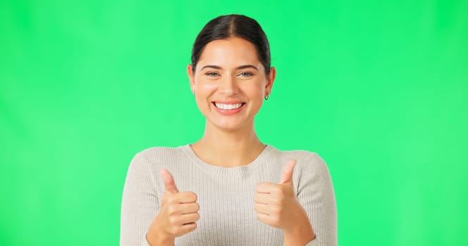 Happy woman, hands and thumbs up on green screen for agreement, good job or winning against a studio background. Portrait of female smile showing thumb emoji, yes sign or like for winning on mockup