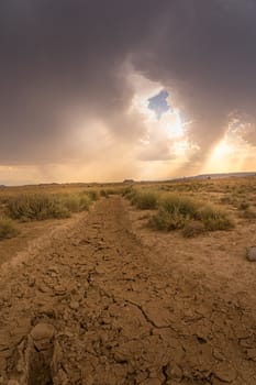 View of Bardenas Reales in Spain with stormy sky and dry ground.