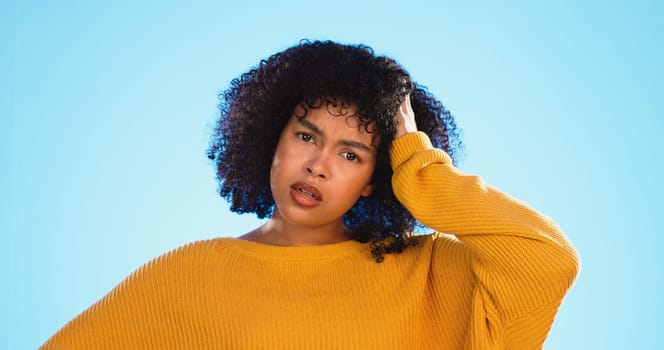 Face, confused and thinking by black woman in studio, pensive and wondering on blue background. Doubt, portrait and unsure girl with decision, choice or emoji on mockup, product placement or isolated