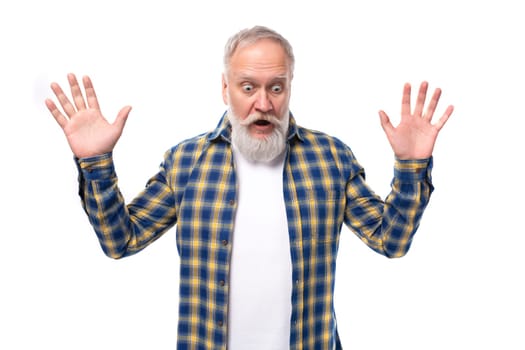 surprised mature gray-haired man with a beard in a shirt waving his hand on a white background
