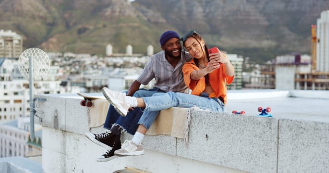 Selfie, rooftop and couple with skateboard and smartphone for social media post, social network update or gen z lifestyle blog with urban cityscape. Influencer black people friends in phone portrait.
