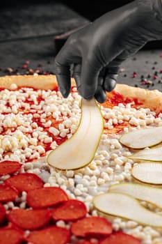 Making a pizza putting pear on a dough