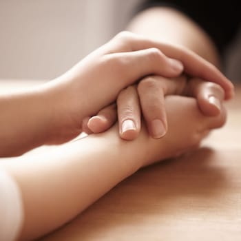 Empathy, support and spiritual with people holding hands in comfort, care or to console each other. Trust, help or love with friends praying together during depression, anxiety or the pain of loss