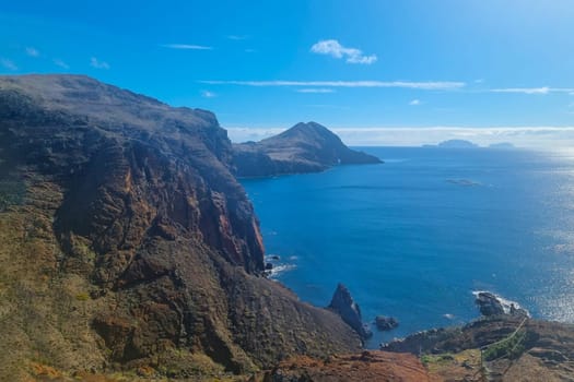 The rocky coast of Madeira Island. A sunny day in the ocean.