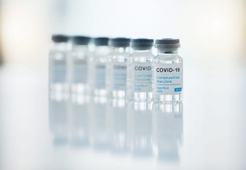 Healthcare, medicine and covid vaccine bottle, stock and product in a hospital office. Healthcare with a virus cure, wellness or corona drug in a medical research clinic for safety from covid 19