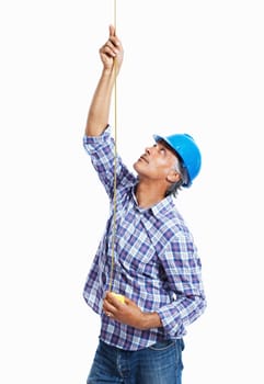 Construction worker. Mature architect in hardhat using measure tape on white background.