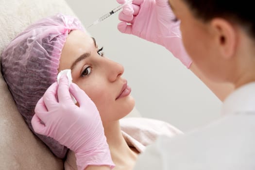Cosmetologist performs the lift procedure by injecting beauty injections. Doctor injecting hyaluronic acid as a facial rejuvenation treatment