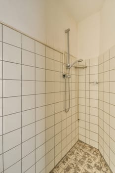 a white tiled shower in a white tiled