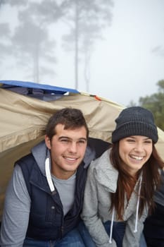They love camping trips. a young couple enjoying their camping trip.