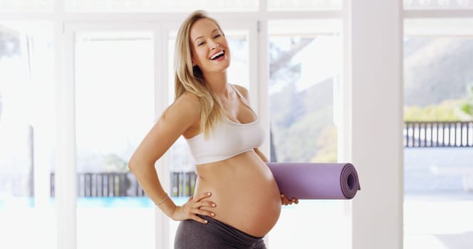 Having fun with fitness. Cropped portrait of an attractive young pregnant woman carrying a yoga mat.