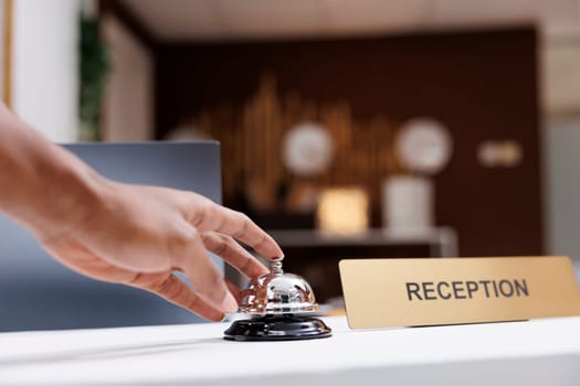 Guest ringing service bell at front desk