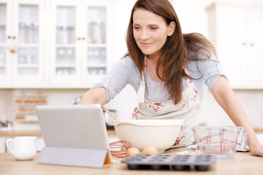 Searching for the perfect recipe. A mature woman looking for baking instructions online.