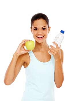 She leads a healthy life. Portrait of a happy young woman holding a bottle of water and an apple.