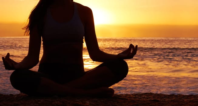 Silhouette of woman meditating in lotus position against sunset. Meditation - Silhouette image of woman in lotus position at sunset.