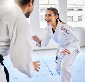 Karate, fitness and teacher with student, combat sports and training for skill development, power and discipline in dojo gym. Fight, happy in taekwondo class and martial arts with sport exercise