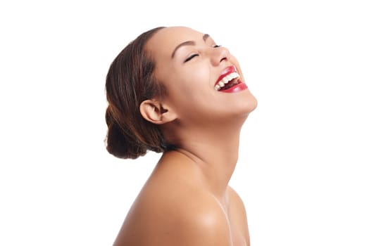 Carefree beauty. Studio shot of a beautiful young woman laughing against a white background.