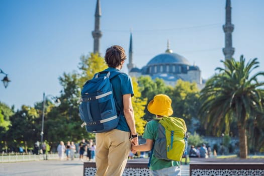 father and son tourists enjoying the view Blue Mosque, Sultanahmet Camii, Istanbul, Turkey. Traveling with kids concept