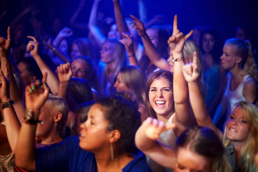 Party, music concert and crowd dancing, happiness and cheerful with joy, fun and night club. Portrait, group or people with a smile, friends or bonding with celebration, social gathering and festival