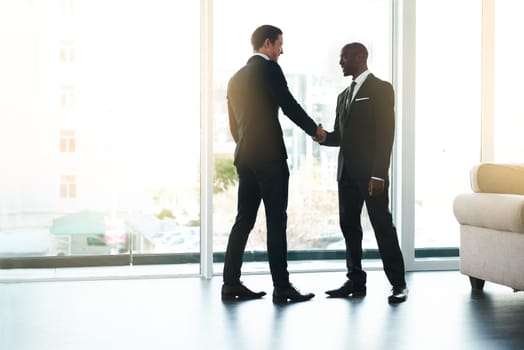 New business relationships bring about new opportunities. Full length shot of two businessmen shaking hands in an office.