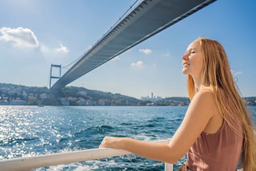 Happy woman enjoying the sea from ferry boat crossing Bosphorus in Istanbul. Summer trip to Istanbul